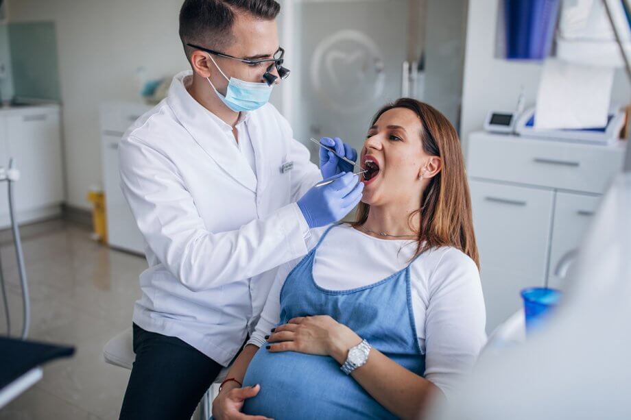 pregnant woman getting a dental exam