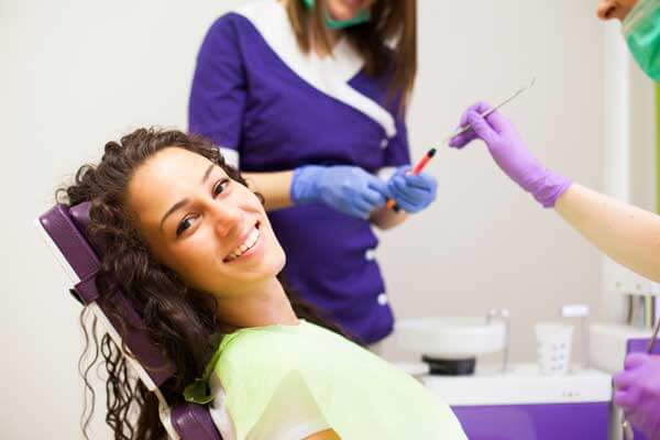 Woman Smiling in Dentist's Chair