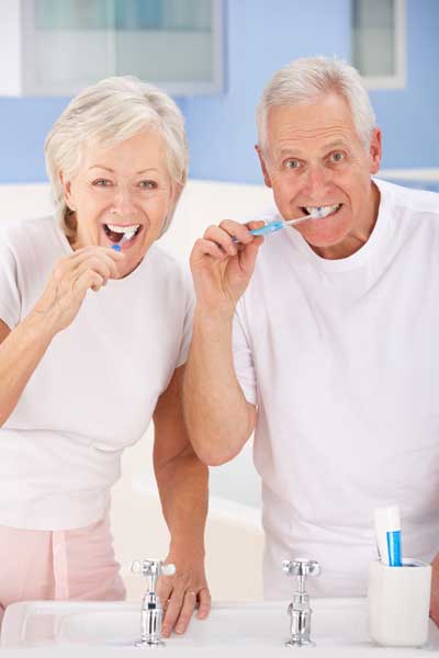 Older Couple Brushing Teeth